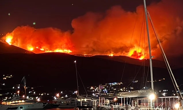 Wildfire 'catastrophe' on Greek holiday island as villages are evacuated and people flee to beaches with huge blaze burning out-of-control