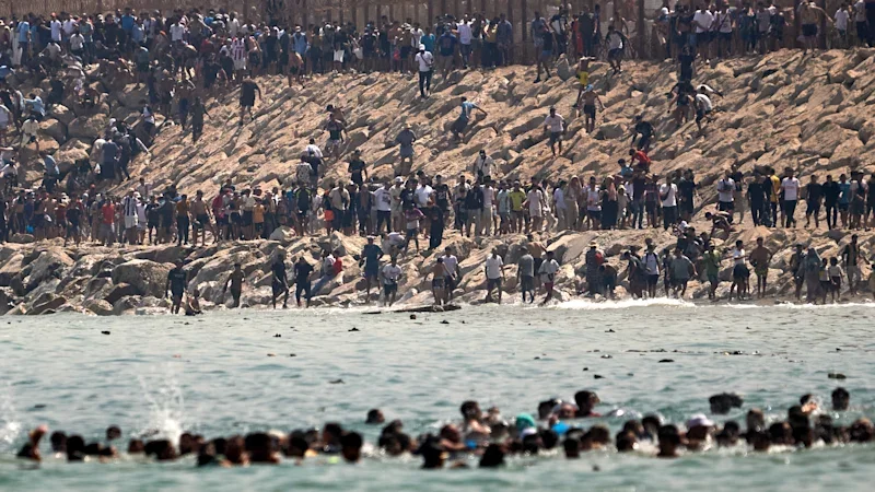 ‘Absolute chaos’: Thousands of people rush across Moroccan border, hoping to get to Europe