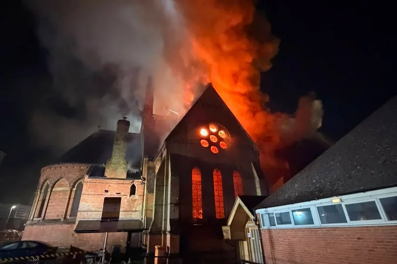 Firefighters rush into burning church to rescue coffin from devastating fire