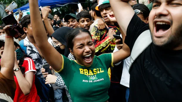 Youth protesters celebrate after India's education minister resigns following exam leak scandal