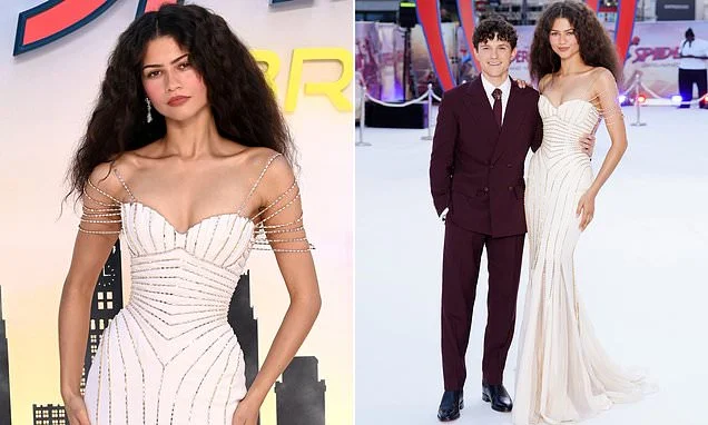 Zendaya stuns in a plunging white gown with silver web design as she joins husband Tom Holland at the Spider-Man premiere - as impressed fans declare 'Marvel is SO back!' in first reviews