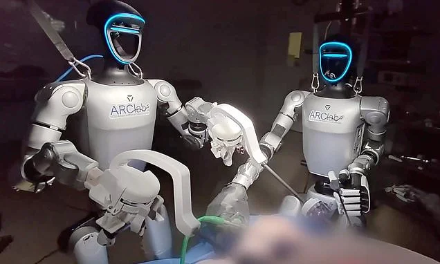 What could go wrong? Watch as two humanoid robots perform SURGERY on pigs - as scientists say humans could be next
