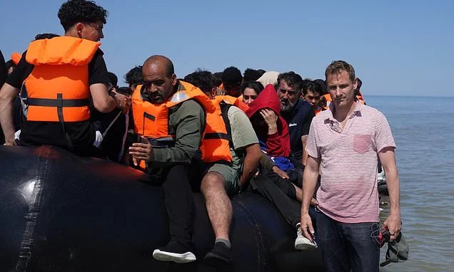 Philp blasts Mahmood's deal with France after gendarmes tell him they have orders 'not to intervene' as migrants wait to board small boats