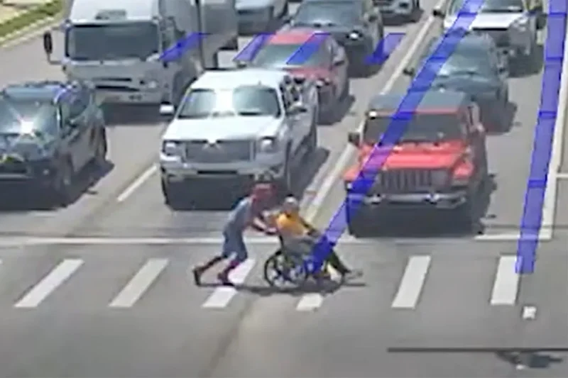 Real-life Spider-Man helps man in wheelchair cross traffic in full superhero costume