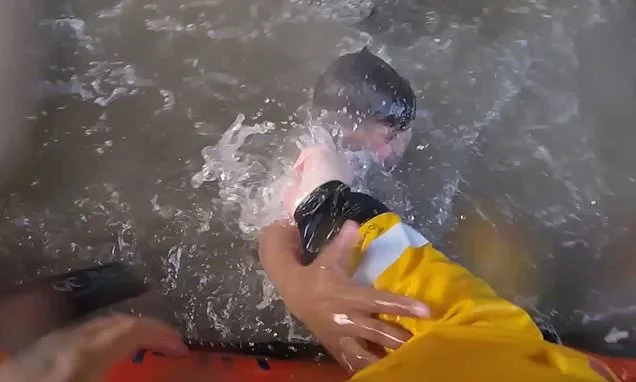 Moment two boys seconds away from drowning are rescued by RNLI in choppy waters beneath Blackpool pier