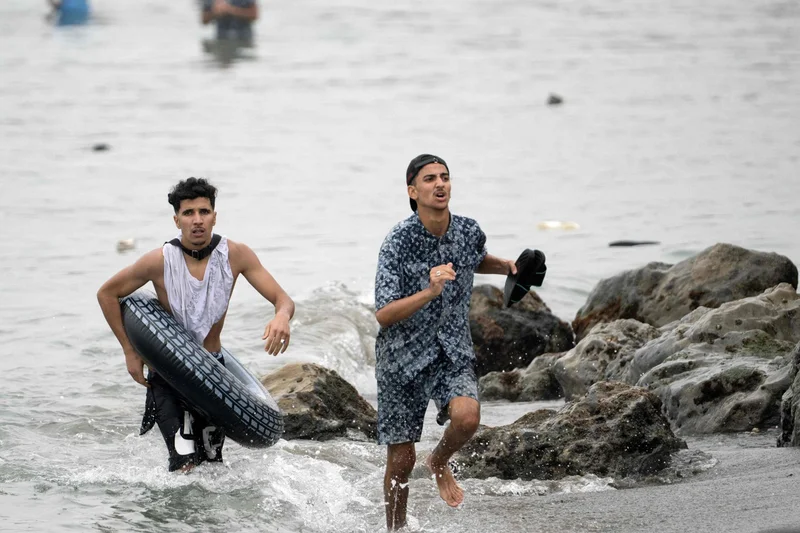 At least 18 die after thousands breach border between Morocco and Spanish territory of Ceuta