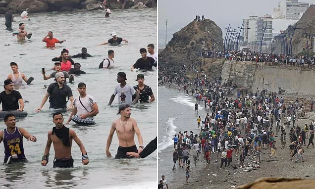 The day 60,000 migrants swept their way into Europe: Wave after wave of incomers storm Spanish city from neighbouring Morocco as protesters throw Nazi salutes