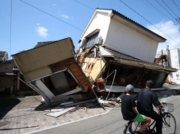 Powerful earthquake in Japan leaves at least 13 dead as efforts to rescue survivors continue