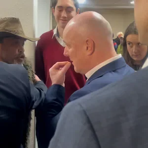Christopher Luxon in Rotorua: Minister Todd McLay gets between Luxon and angry local at public meeting