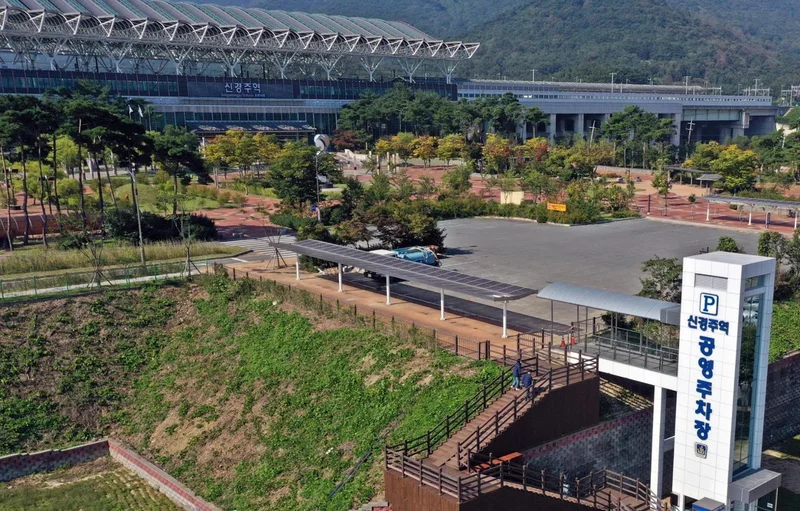 Why were Korea's high-speed rail stations built so far from city centers?