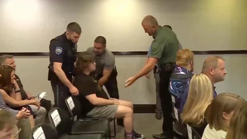 Kansas teacher dragged out in handcuffs after clapping at data center meeting