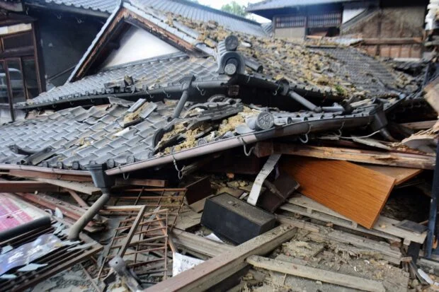 Japan earthquake kills 13; rescuers search for survivors