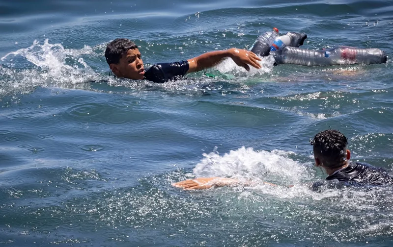 Hundreds of migrants swim from Morocco to Spain's Ceuta territory