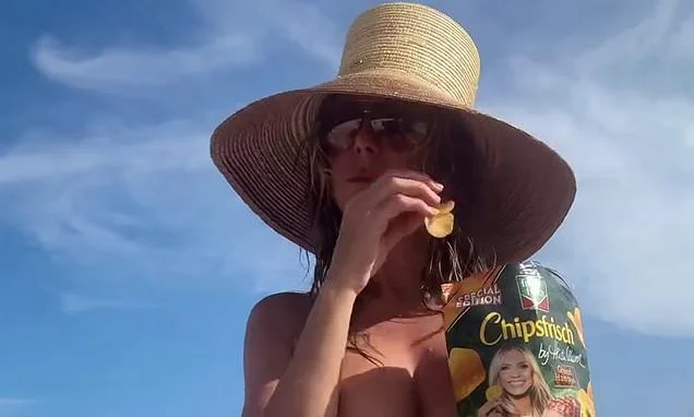 Heidi Klum, 53, goes topless to plug her German crisp collaboration before enjoying a dip with her dog in the ocean during fun-filled beach trip