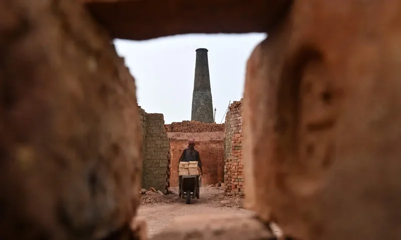 'Work is work, it has to be done': Brickmakers in Pakistan scorched by sun above and fire below