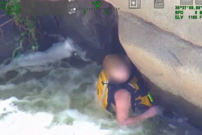 Dramatic rescue after woman found clinging to underside of cliff amid raging torrents of California river