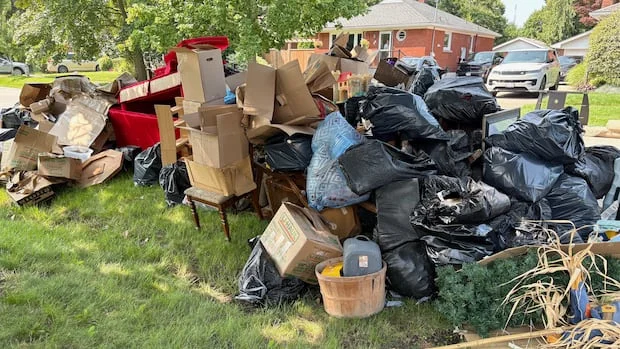 93-year-old's 'lifetime of memories' piled on a curb in St. Catharines, Ont., after flooding