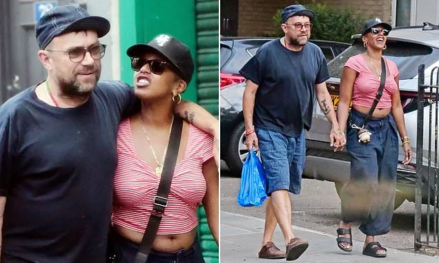 Damon Albarn looks loved up with new girlfriend Rebecca Freckleton during cosy stroll as they 'take their romance to the next level' - four years after his split from ex Suzi Winstanley