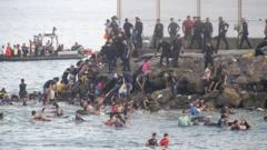EU calls for strengthening borders after thousands of migrants pour into Spain from Morocco