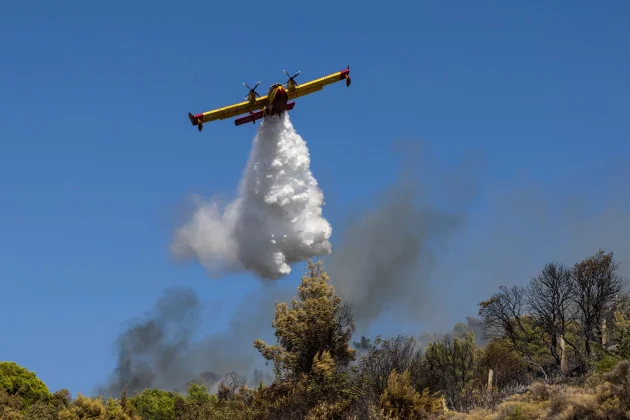Firefighters in Greece struggle to save coastal resort as violent winds rage