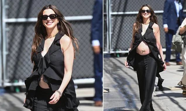 Pregnant Anne Hathaway flashes baby bump at Jimmy Kimmel after addressing speculation that she faked baby bump