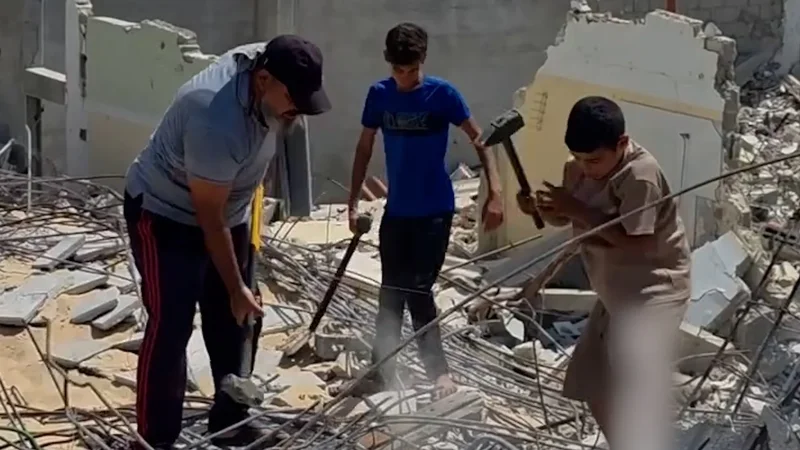 Father and sons forced to manually clear rubble in Gaza