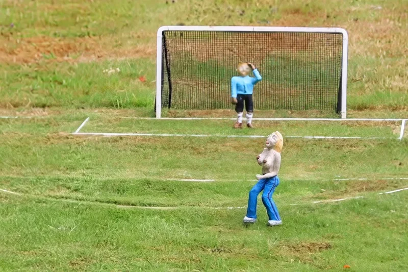 Topless streaker figurine welcomed back to model village after local fury over removal