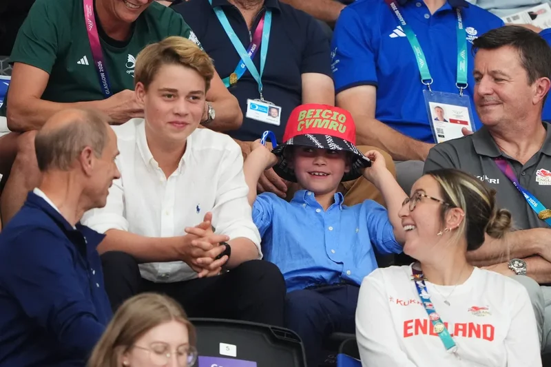 Grinning Prince Louis dons bucket hat as he watches Commonwealth Games alongside family