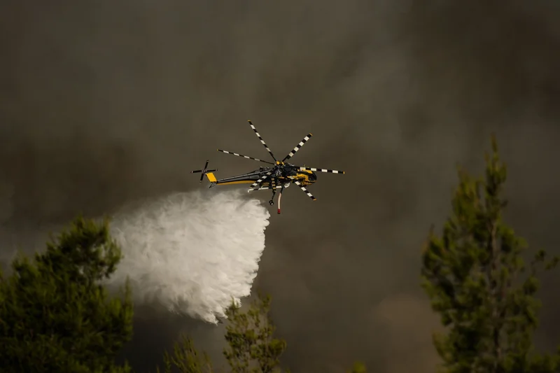 Greece's fight against wildfire turns somber after choppers collide
