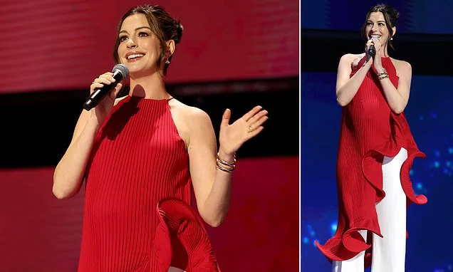 Pregnant Anne Hathaway, 43, covers baby bump in quirky red look at Disney event... after being roasted over maternity style