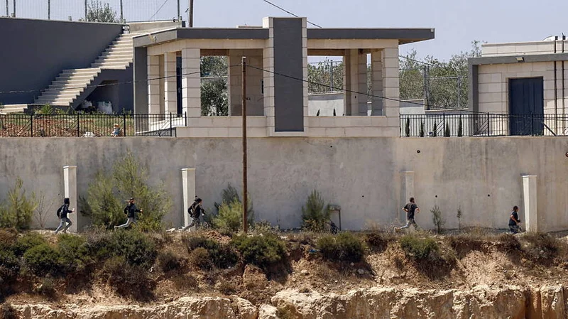 Israel sends troops into West Bank homes besieged by Jewish settlers