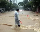 Torrential rains kill one in South Korea while Philippine capital battles major flooding