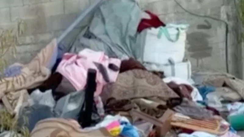 Israeli soldiers throw belongings from besieged Palestinian home