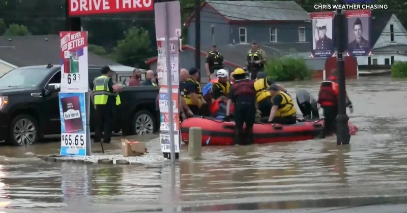 First responders use boats to rescue people from flooded homes, cars in Midwest
