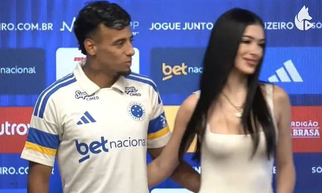 Awkward moment footballer is blanked by his girlfriend dubbed 'Uruguay's Kim Kardashian' after swooping in for a kiss at his transfer unveiling... before hilariously trying to style it out