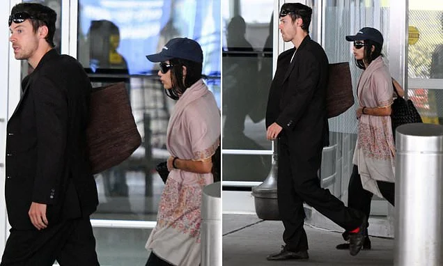 Harry Styles looks smart in a black suit as he touches down in New York with fiancée Zoe Kravitz ahead of his 30-date residency in Madison Square Garden