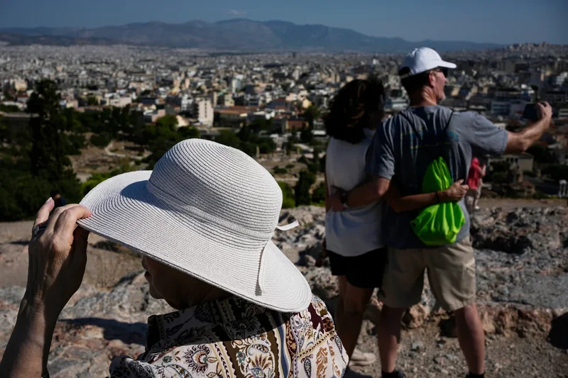 The sunhat is everywhere in Athens as crowds grow larger at ancient sites