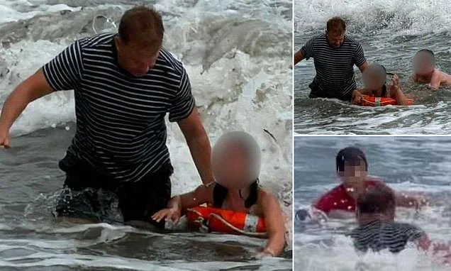 Moment heroic cafe owner plunges into the waves to save three children he spotted getting into difficulty in rough sea