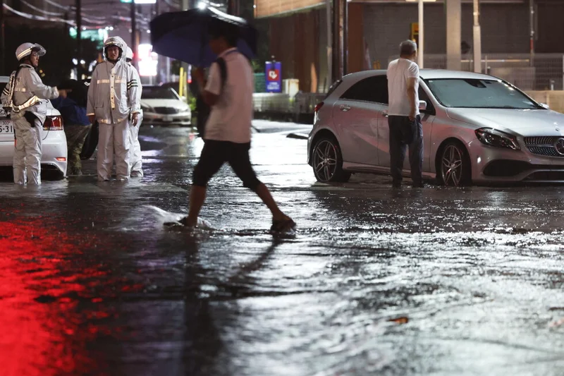 Heavy rain causes flooding near Tokyo that kills 4 and disrupts train and air travel