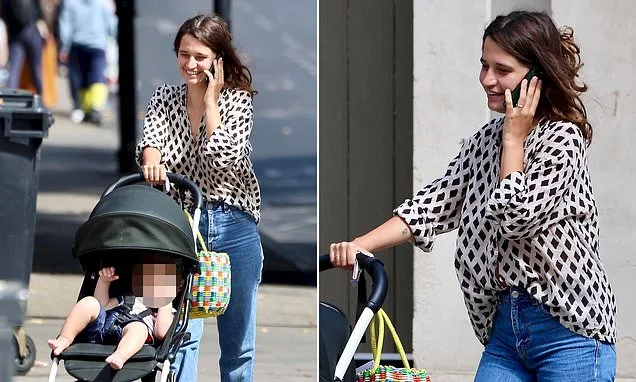 A new sensation! Michael Hutchence's daughter Tiger Lily is a natural at motherhood as she takes her baby out for a stroll in a pram and flashes her wedding band from husband Ben Archer