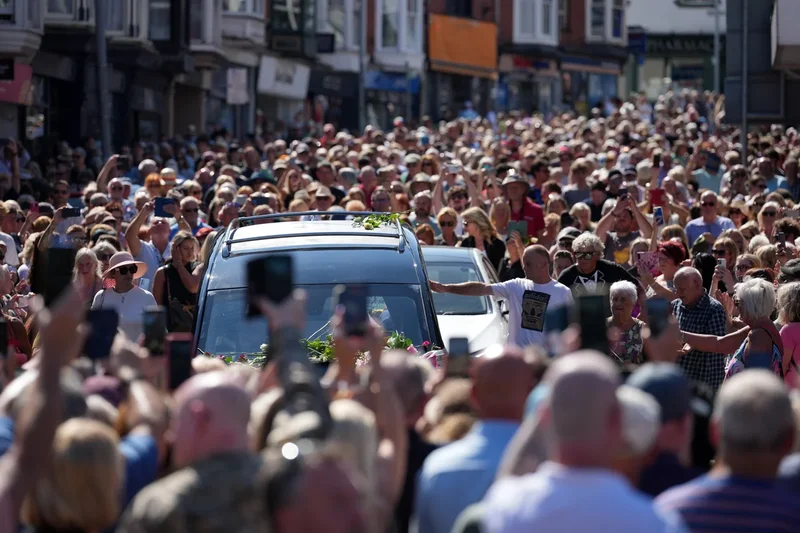 Bonnie Tyler fans line the streets of a Welsh village as her coffin is brought home