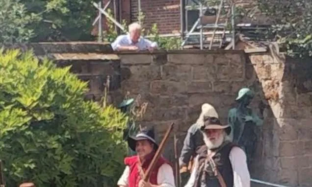 'F*** off back to Worcester!' Moment disgruntled neighbour scales wall and starts shouting abuse at Civil War reenactors in front of the Town Mayor and families