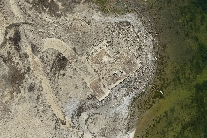 Remains of lost village uncovered as drought lowers reservoir levels in record-breaking heatwave