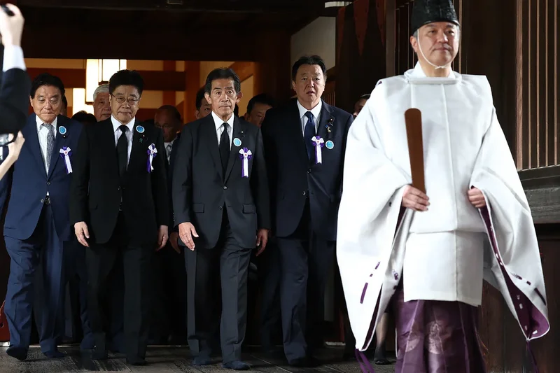 Japan PM stays away from shrine to WWII dead but defence minister’s visit angers neighbours