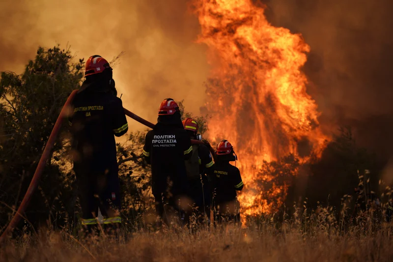 Greece wildfire in pictures: Firefighters battle blaze worsened by 100km per hour winds