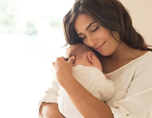 Infants' sense of agency develops through culture-specific caregiver interactions