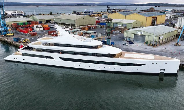 This superyacht makes a splash! £220m mega-vessel with giant swimming pool on board for its 'keen swimmer' owner moors up off South Coast