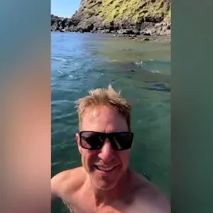 Northland-based fishing host Matt Watson jumps into freezing sea for annual winter swim with dolphins