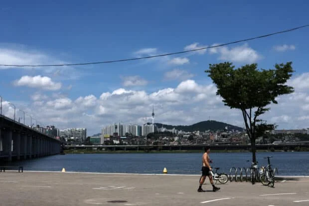 Summer returns in S. Korea, so does debate over shirtless runners